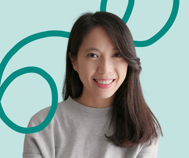 A woman smiling grey sweater